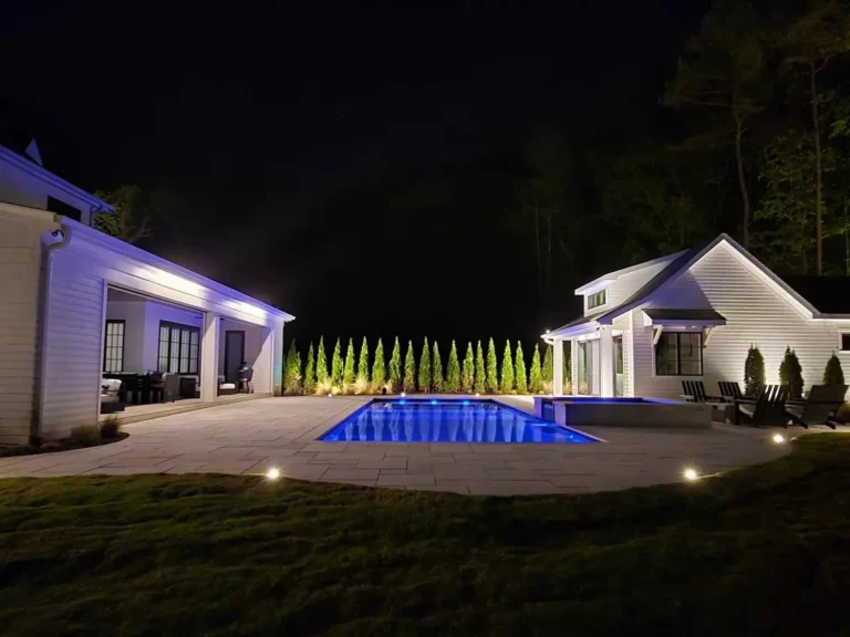 Hardscape and pool lighting illuminating a residential outdoor living space in Raleigh, North Carolina